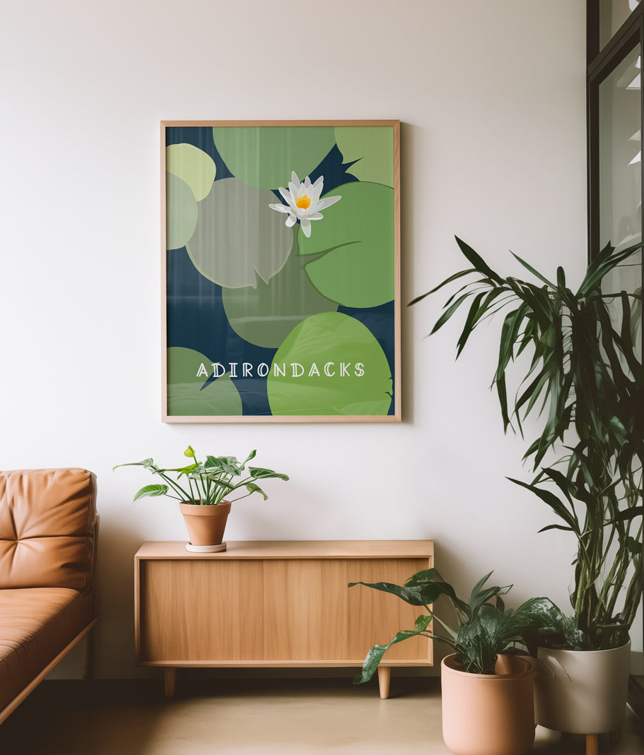 Framed illustration in living room of lily pads and water lily flower with words Adirondacks. 