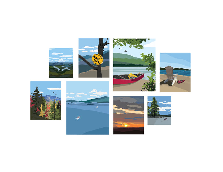 Set of eight illustrated Adirondack themed art prints featuring various outdoor scenes including a canoe on a lake, an Adirondack chair on a beach, a high peaks image in fall, lake placid from the top of whiteface, a foot trail marker on a tree, a sunset and two lake prints, one with a loon and one of lake George.