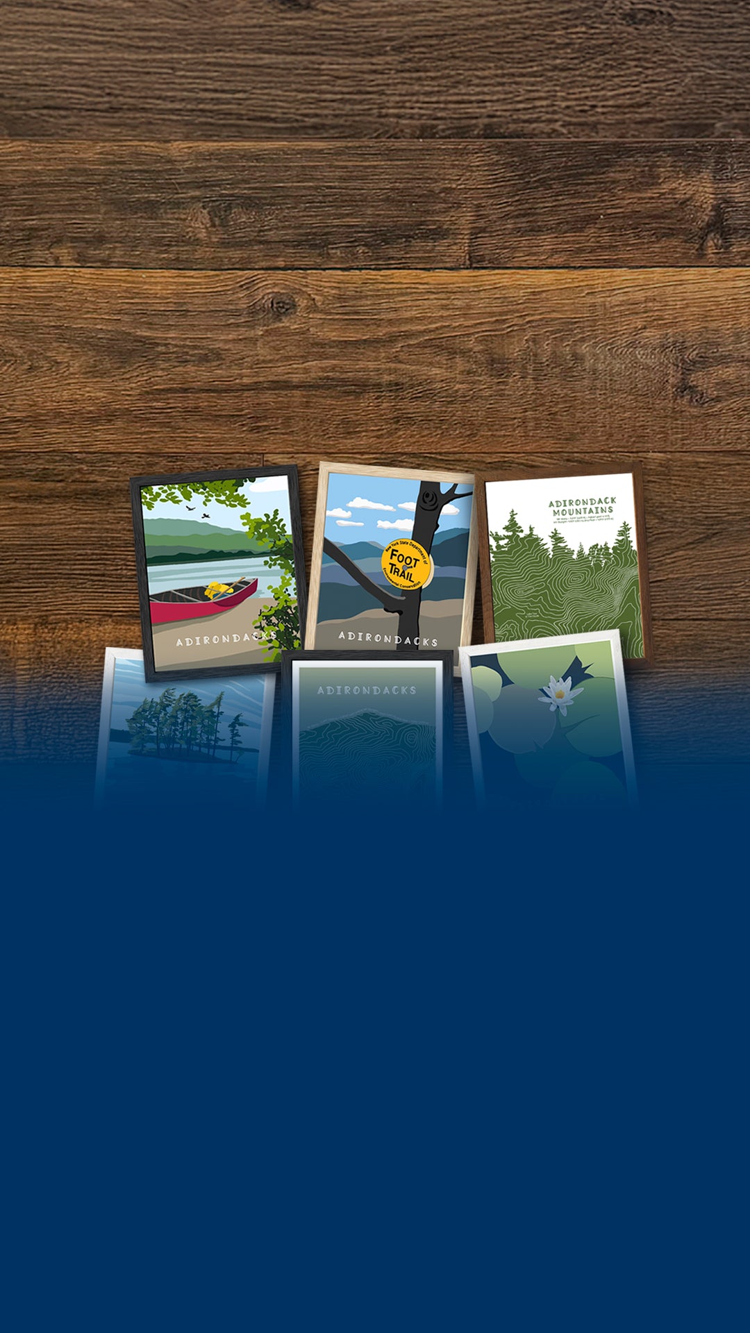 Framed artwork featuring scenes from New York State's Adirondack Park sitting on a wood background with a blue band of color at the bottom of the image.