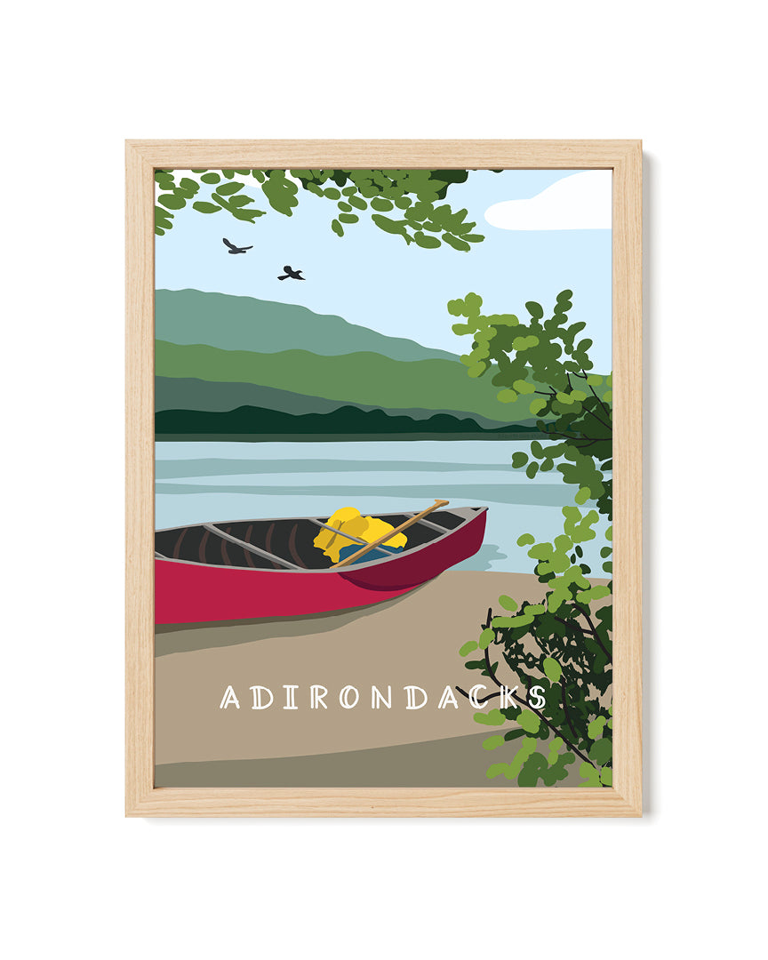 Framed artwork of a lake scene with a red canoe, trees, and mountains, labeled &