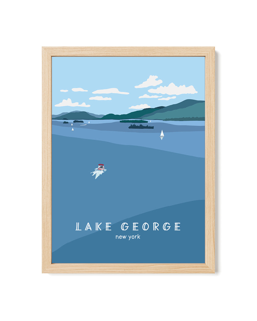 Framed artwork of Lake George, New York with boats on the water and blue sky and mountains.