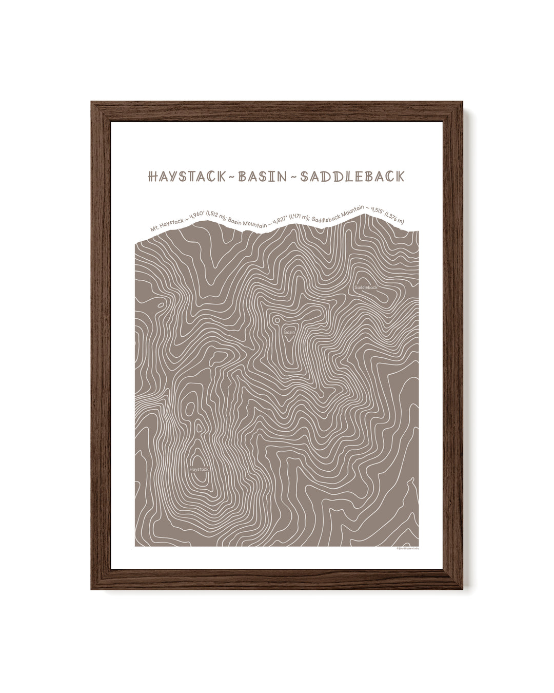 Walnut framed topographic map art of Haystack, Basin and Saddleback peaks in brown line patterns on a white background