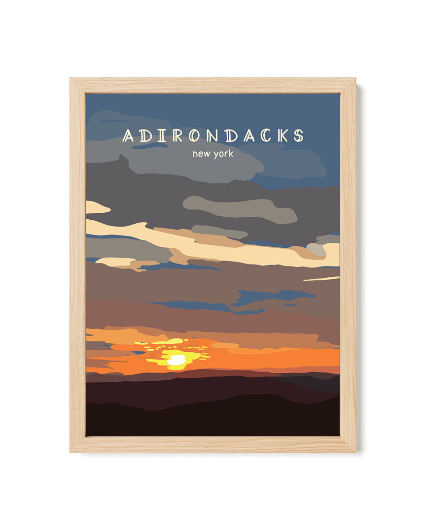 Framed artwork of a sunset over mountains with &