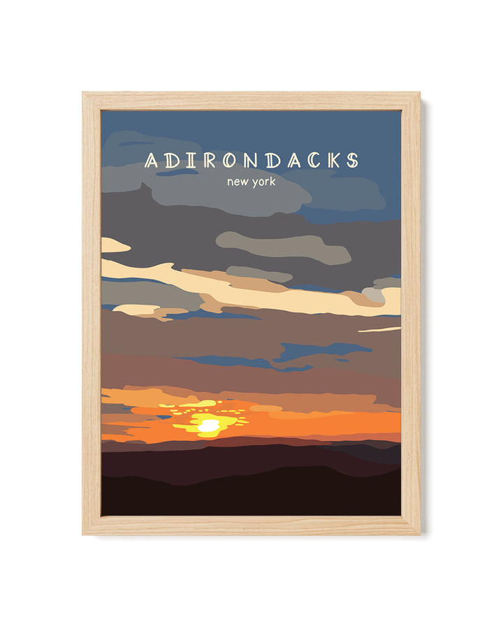 Framed artwork of a sunset over mountains with &