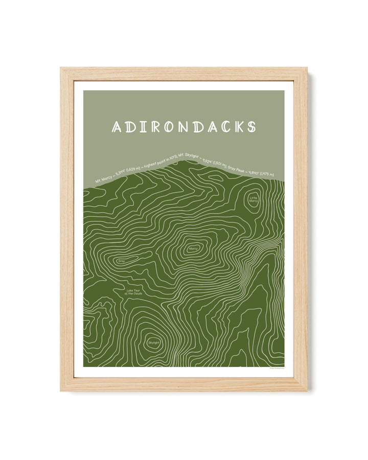 Framed topographic map of the Adirondacks with a light wood frame on a white background.