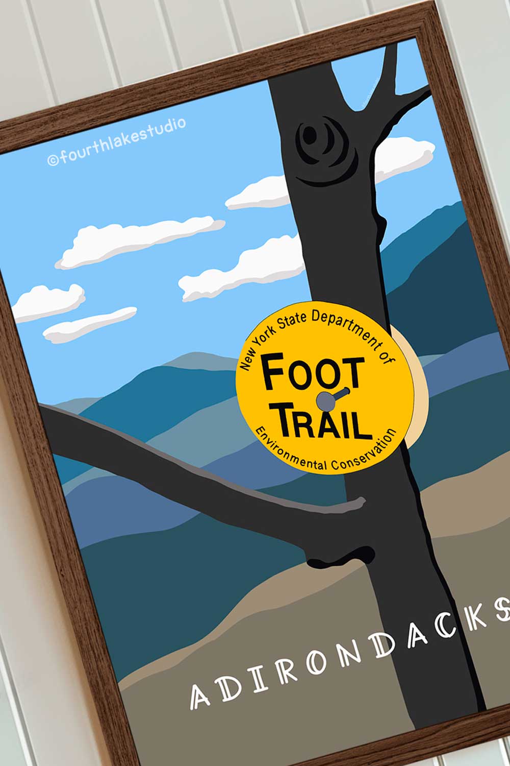 Framed poster of a tree with a 'Foot Trail' sign and Adirondack Mountains in the background.