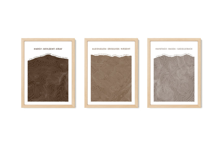 Framed Natural set of three topographic map art prints of Mount Marcy, Skylight &amp; Gray, Algonquin, Iroquois &amp; Wright Peaks, Haystack, Basin and Saddleback peaks in brown line patterns on a white background